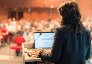 business-woman-lecturing-conference-audience-260nw-203936089